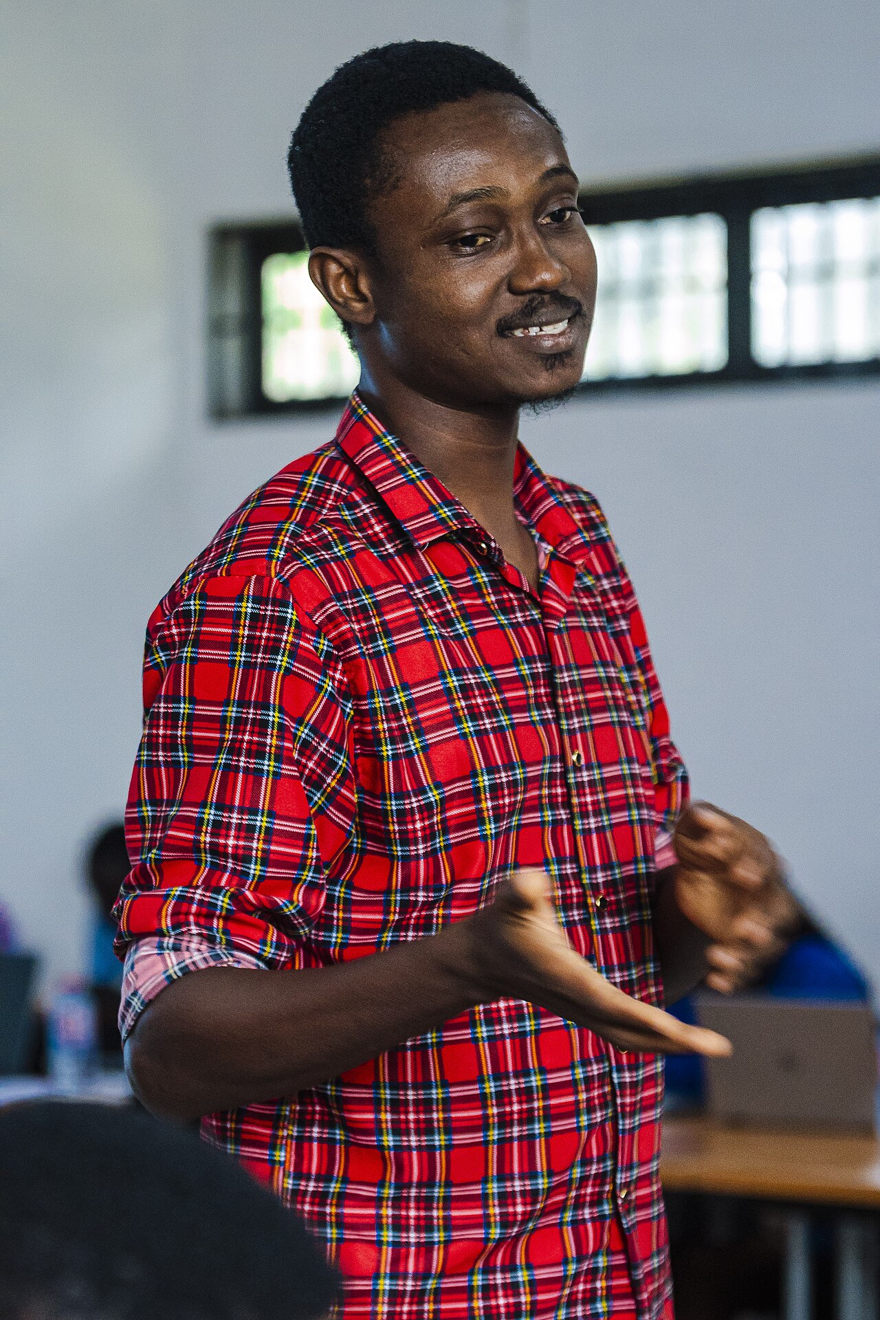 A young Ghanaian man speaking during a University of Ghana workshop